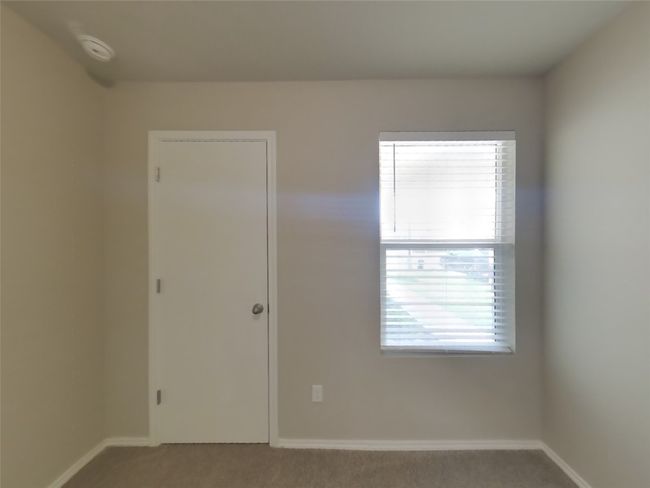 Spare room featuring a smoke detector and carpet floors | Image 10