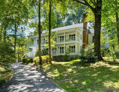 View of front of home featuring a balcony and a front yard | Image 1