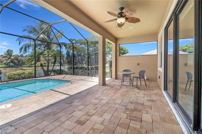 Outdoor pool featuring a patio, ceiling fan, and a lanai | Image 8