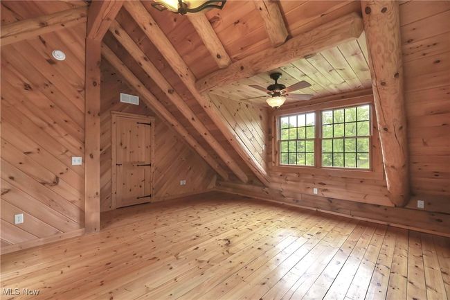 View of wood floors and front windows in primary bedroom | Image 28