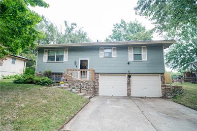 Raised ranch featuring a garage and a front lawn | Image 2