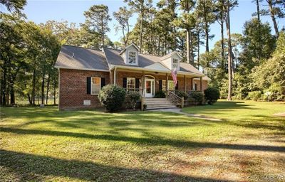 Rear view of house featuring a yard and covered porch | Image 1