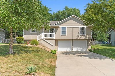 View of front facade featuring a garage and a front yard | Image 1