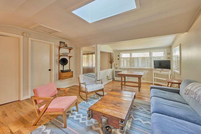Living room with attic access, lofted ceiling, and light wood finished floors | Image 5