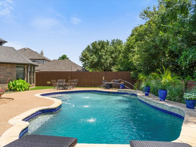View of swimming pool with a fenced backyard, a patio area, and outdoor dining space | Image 31