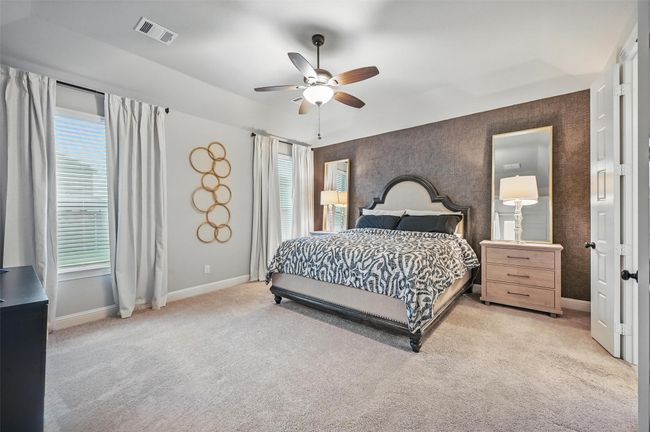 Bedroom featuring multiple windows, light carpet, and a ceiling fan | Image 20