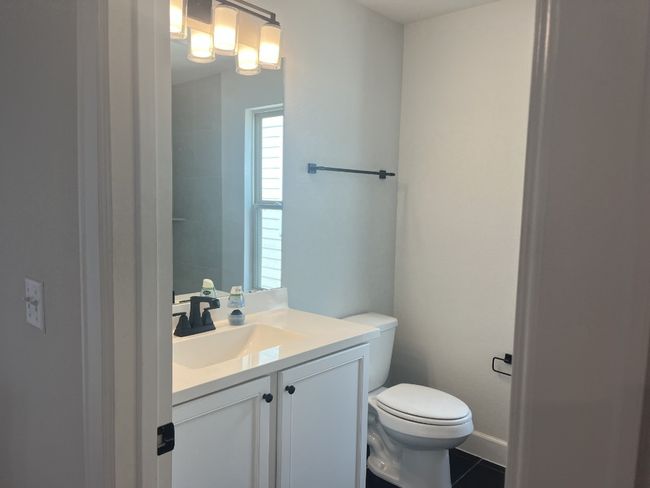 Bathroom with toilet, tile patterned floors, and vanity | Image 31