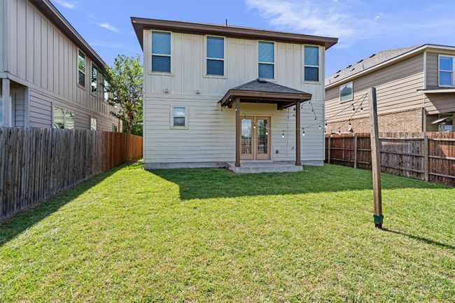 Back of house featuring french doors, board and batten siding, and a fenced backyard | Image 37