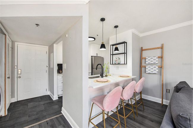 Viewof front door, laundry closet, kitchen and breakfast bar | Image 5