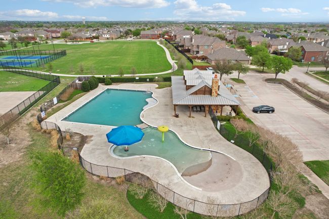 View of pool with a water play area, a residential view, and fence | Image 36