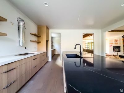 Kitchen featuring sink, light brown cabinetry, and dark hardwood / wood-style flooring | Image 3