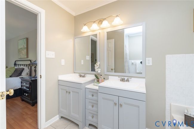 Ensuite bathroom with vanity, crown molding, a bath, and wood finished floors | Image 23