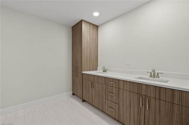 Bathroom featuring tile patterned flooring and dual bowl vanity | Image 25