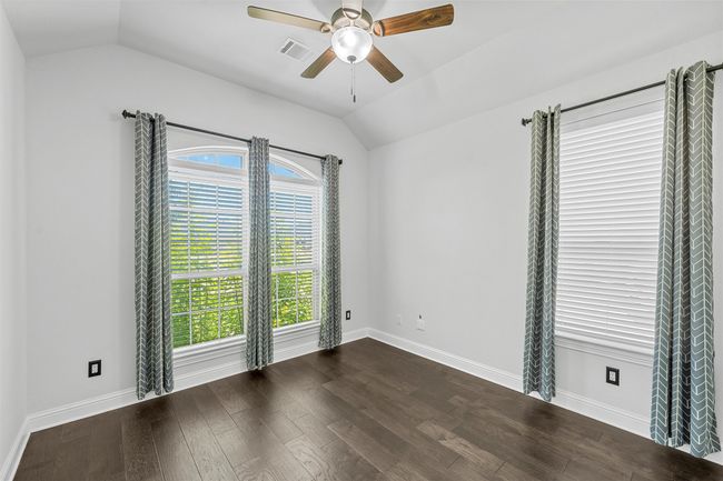 Spare room with vaulted ceiling, plenty of natural light, a ceiling fan, and dark wood-style floors | Image 23