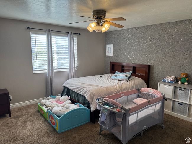 Bedroom featuring carpet floors, a textured ceiling, and a ceiling fan | Image 7