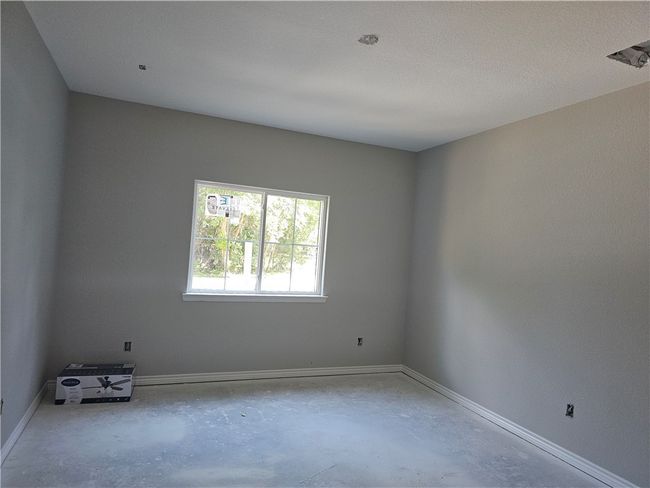 Unfurnished room with concrete flooring and baseboards | Image 6