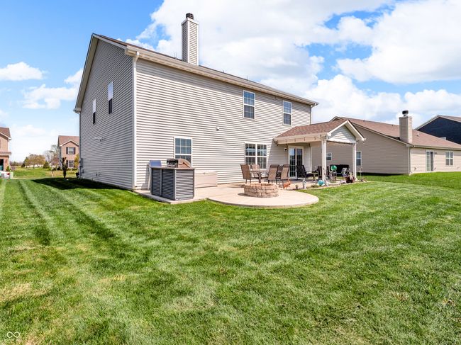 back of house featuring a yard, a fire pit, , and a patio area | Image 42