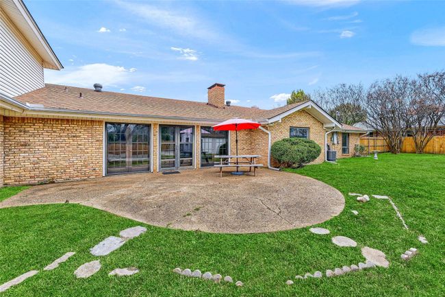 Back of property with a patio, a chimney, brick siding, and roof with shingles | Image 39