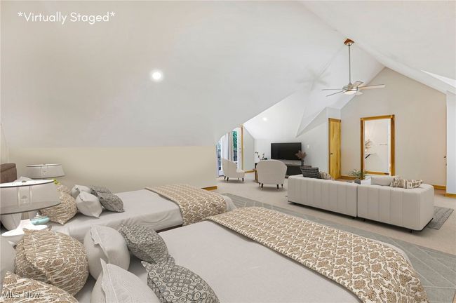 Bedroom with carpet floors, a ceiling fan, and high vaulted ceiling | Image 34