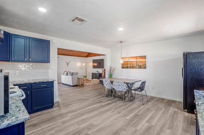 The kitchen and dining spaces open easily to the living area, creating a connected flow throughout the main living spaces. | Image 13