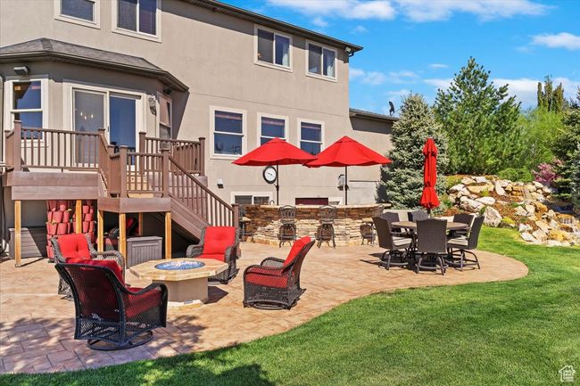View of patio featuring stairway, a deck, a fire pit, and area for grilling | Image 51