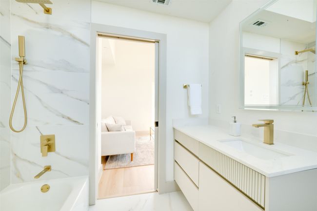 Bathroom with vanity, tiled shower / bath, and hardwood / wood-style floors | Image 33