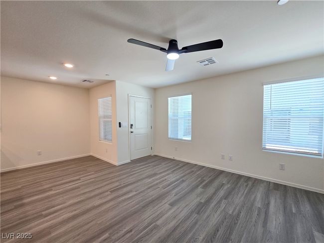 Unfurnished room with dark wood-type flooring, ceiling fan, baseboards, and recessed lighting | Image 4