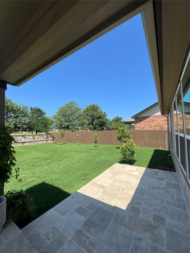 View of yard featuring a fenced backyard and a patio | Image 24