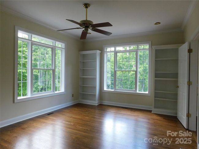 Plenty of light and built in bookcases beckons the one who enjoys reading in bed. | Image 25