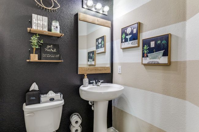 Bathroom featuring toilet and a textured wall | Image 21