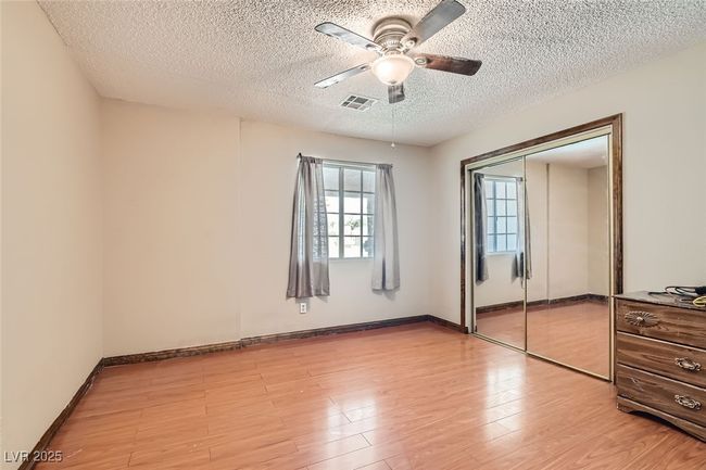 Unfurnished bedroom featuring a closet, visible vents, light wood-style floors, a ceiling fan, and baseboards | Image 21