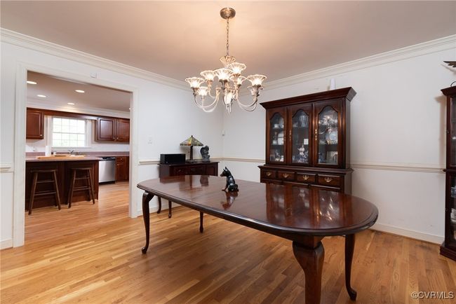 Formal dining room with beautiful hardwood floors, crown and chair rail moldings | Image 15