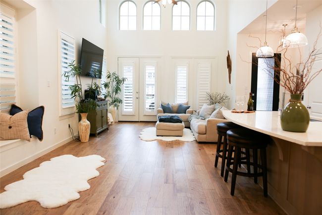 Living room featuring wood finished floors and a towering ceiling | Image 12
