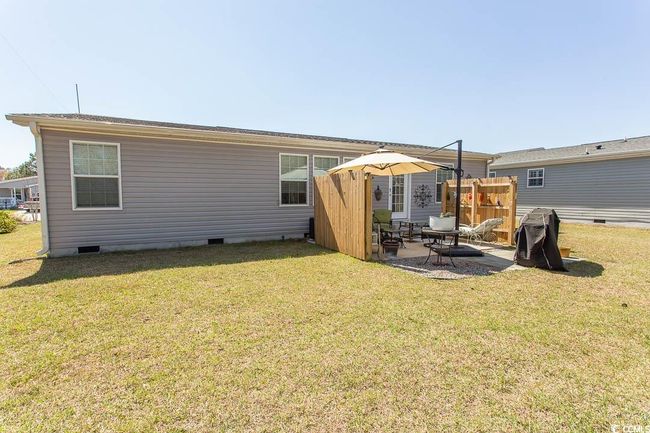 Back of property with a lawn, a patio, and crawl space | Image 39