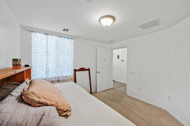 Bedroom with light carpet and baseboards | Image 15
