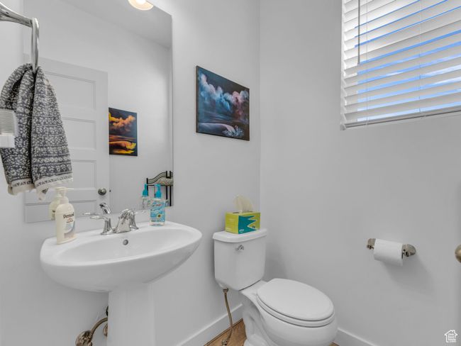 Half bath featuring baseboards and wood like finished floors | Image 21