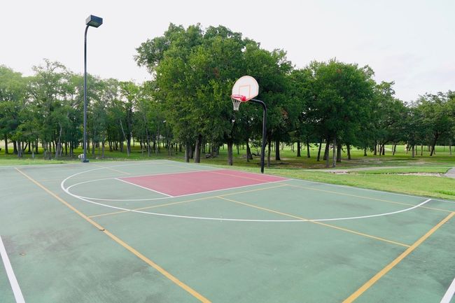 View of sport court with community basketball court and view of wooded area | Image 35