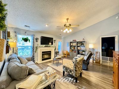 New vinyl plank. Vaulted ceiling and wood burning fireplace. | Image 2