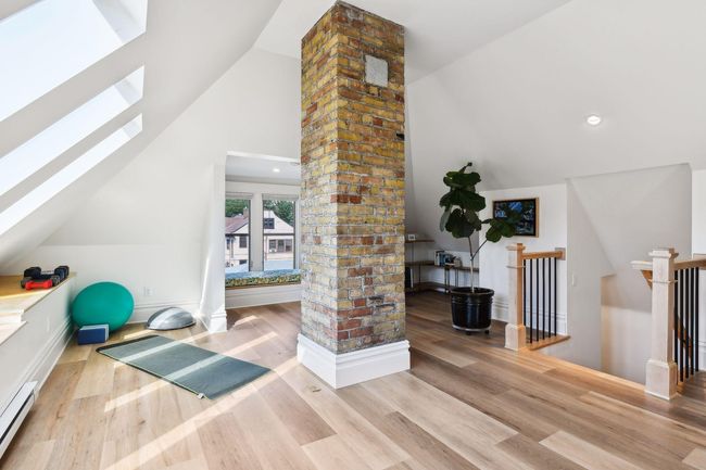 Amazing attic remodel offers an incredibly bright and spacious flex room with Luxury Vinyl flooring. | Image 19