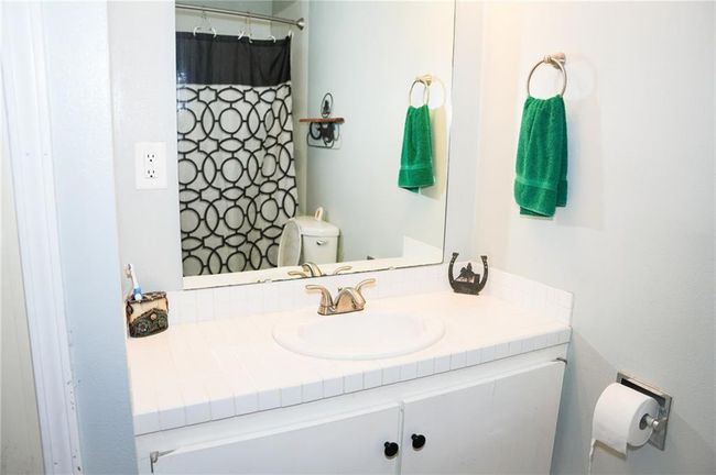Bathroom featuring toilet and vanity | Image 12