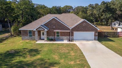 View of front facade featuring a front lawn and a garage | Image 3