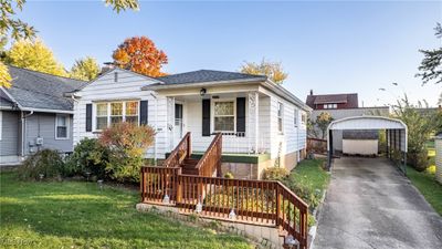 Bungalow featuring a front yard and a carport | Image 3