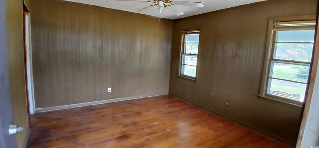 room featuring a ceiling fan, wood finished floors, and healthy amount of natural light | Image 16