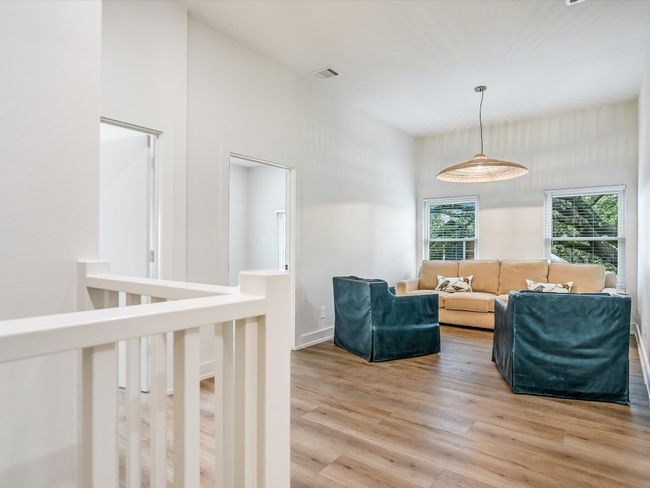 Living area with light wood-style floors and visible vents | Image 10