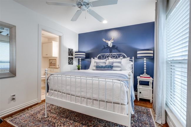 Bedroom featuring ensuite bathroom, wood finished floors, and ceiling fan | Image 20