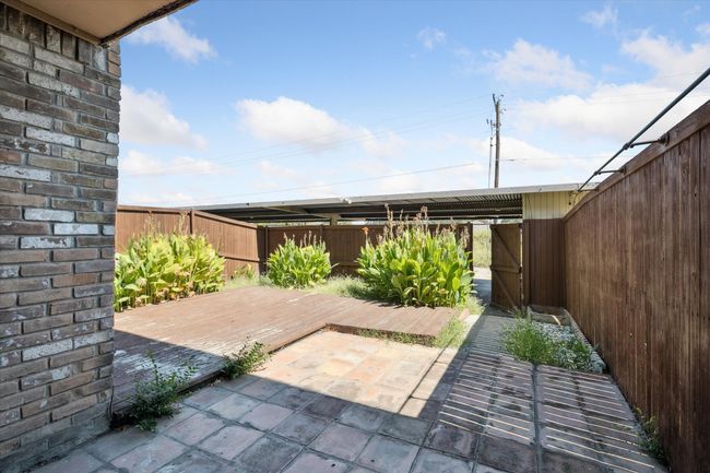 Fenced backyard with a patio area | Image 15