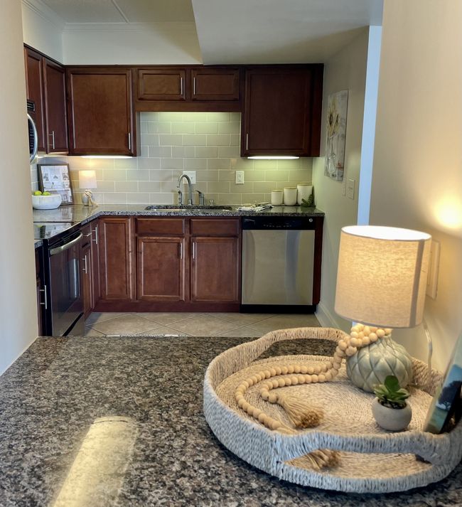 This delightful bar seamlessly connects the kitchen to the living room, allowing an abundance of natural light to flow into the space. Utilize this versatile area for tasks such as managing mail, creating a cozy coffee bar, & serving guests. | Image 7