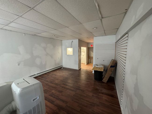 Basement featuring dark hardwood / wood-style flooring and a drop ceiling | Image 5