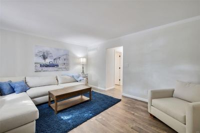 Living room with hardwood / wood-style flooring and crown molding | Image 2