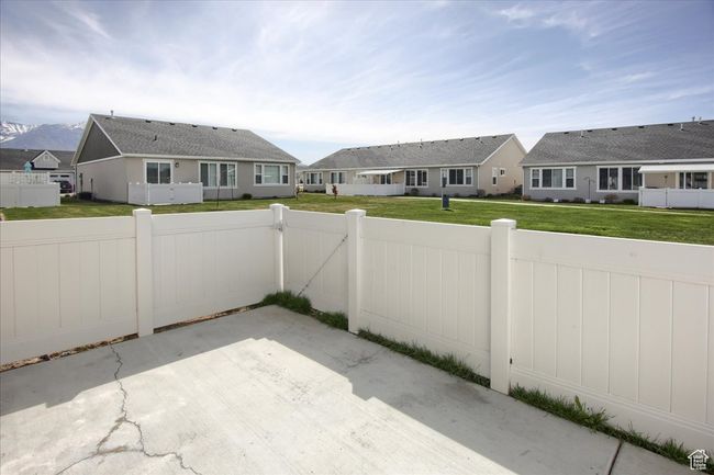View of patio with a residential view, fence private yard, and a gate | Image 23